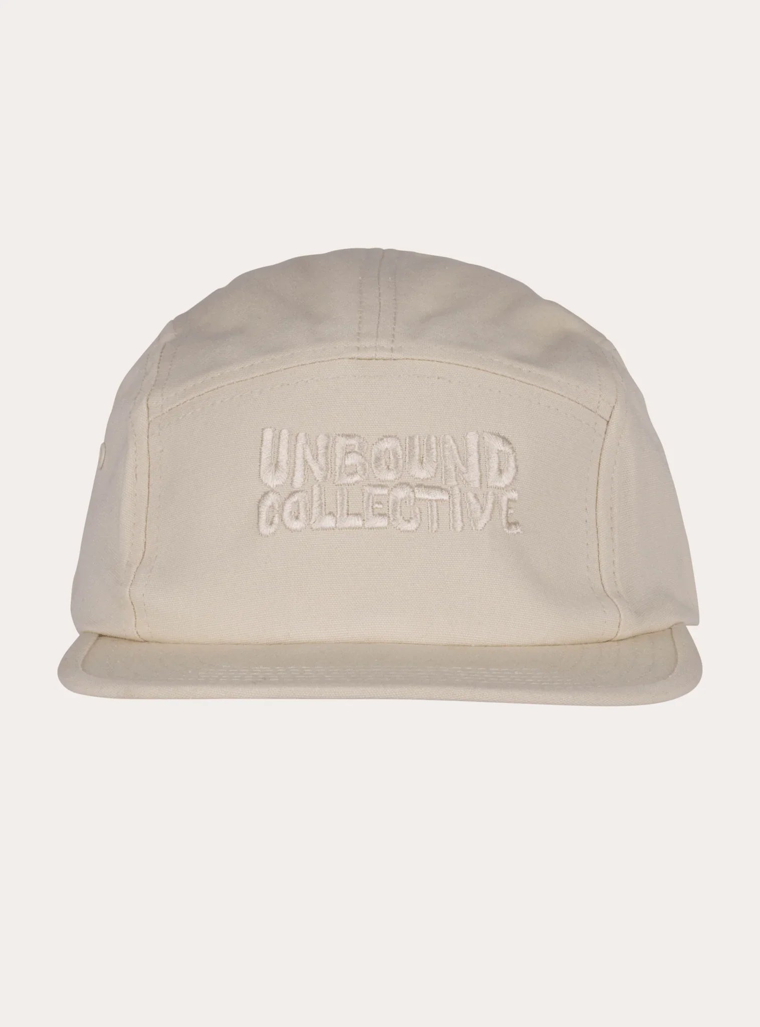 Cream-colored 5-panel hat with embossed Unbound Collective logo, sustainable MTB accessory