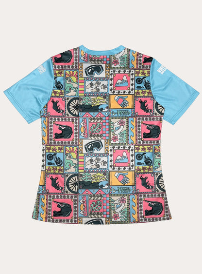 Women's short sleeve MTB jersey with blue sleeves and colorful square pattern featuring bike gear, mountains, gloves, and nature motifs