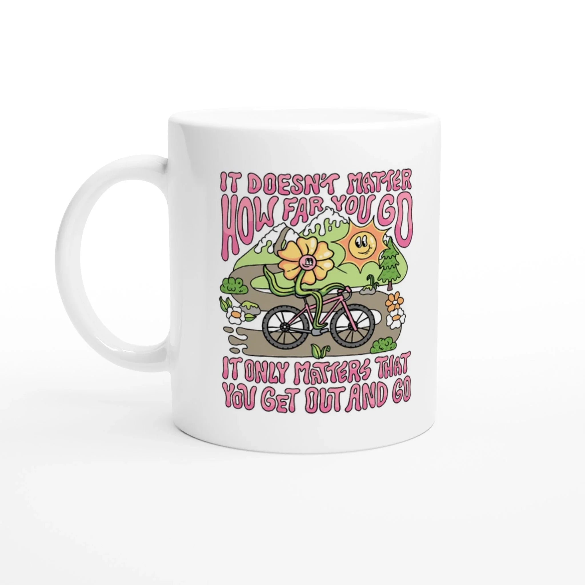 White ceramic mug with colorful mountain biking flower character and motivational text in pink